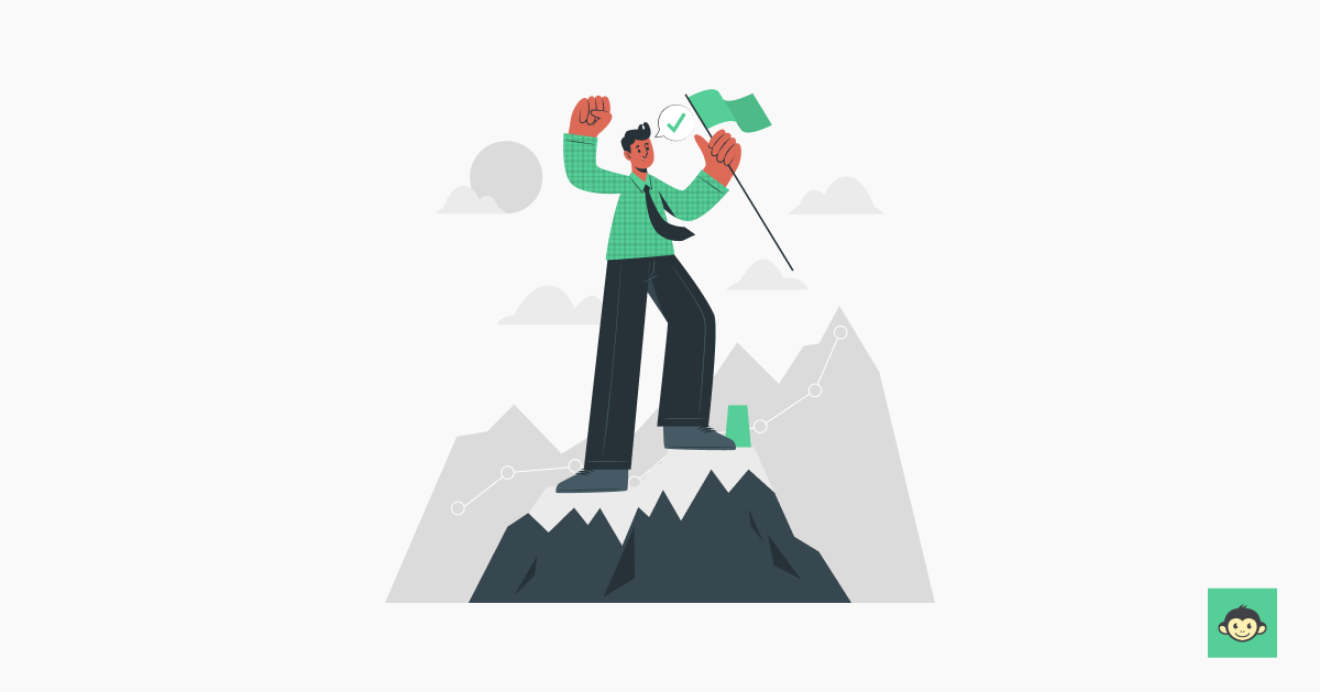 Employee standing on top of a mountain holding a flag 