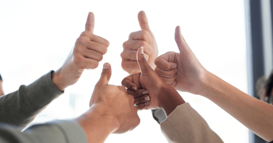 Employees giving each other a thumbs up