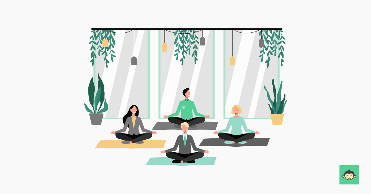 Four employees are meditating in the workplace 