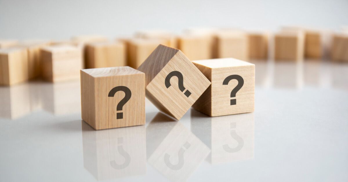 Three wooden blocks with question marks