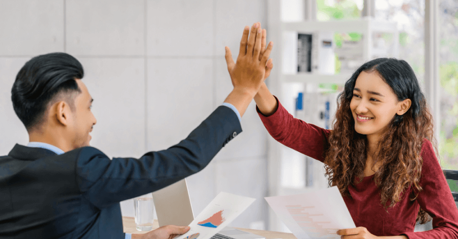 Employees sharing a high-five