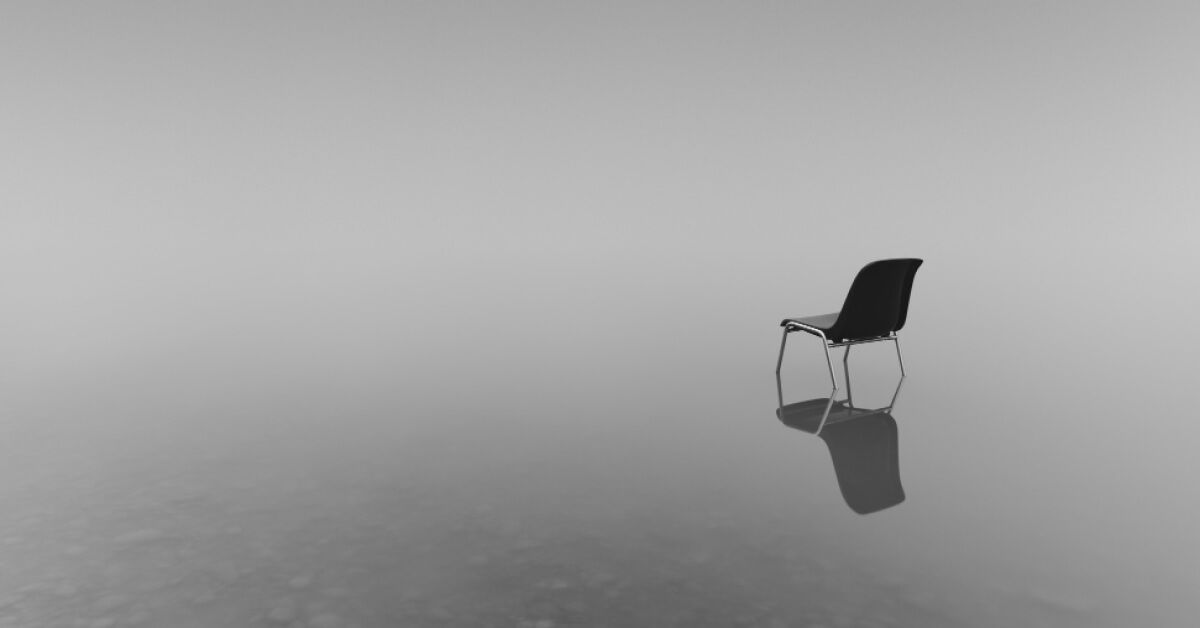 A chair in the middle of a lake 