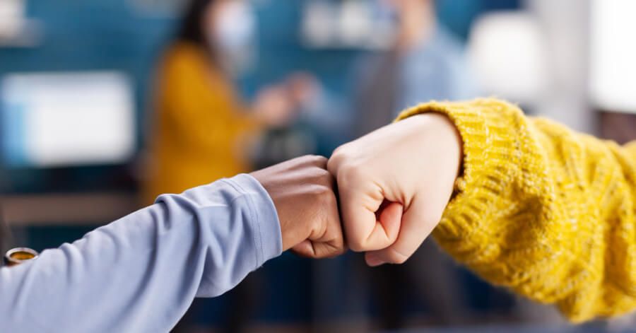 Employees giving each other a fist bump