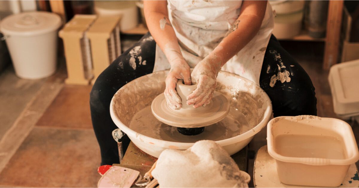 A person making a pot with clay