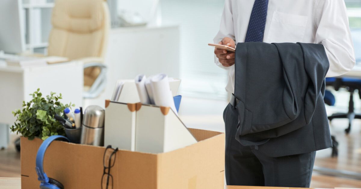 A man standing with a packed box