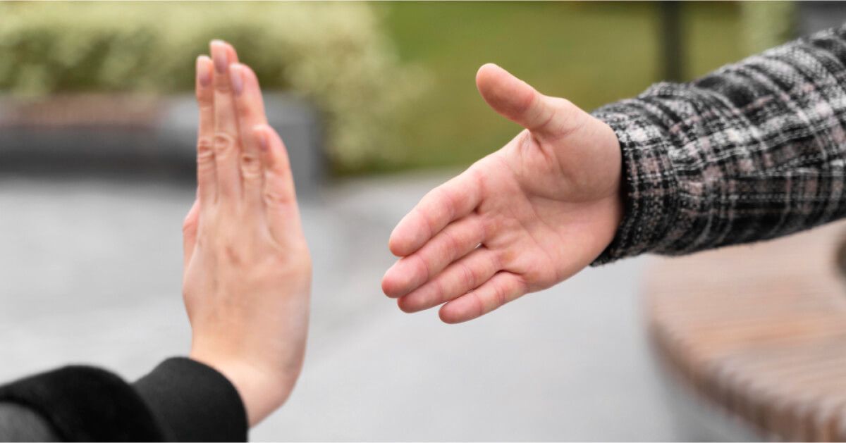 A person refusing to shake hands