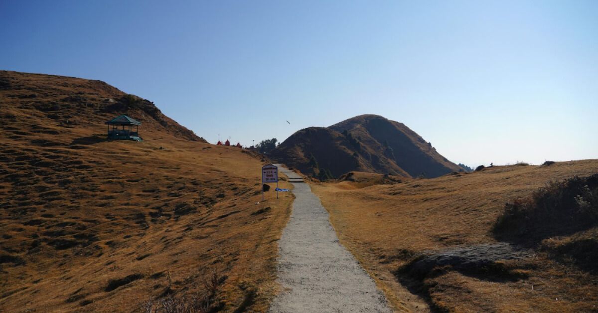 An empty road leads within the mountains 