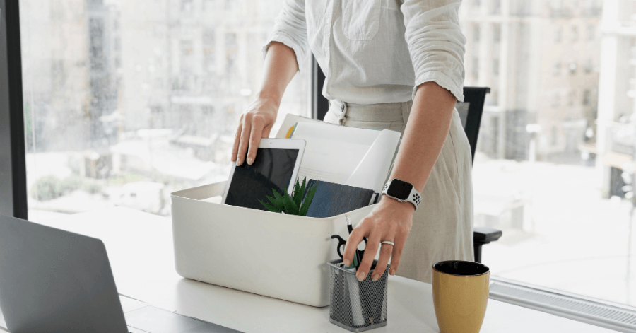 Employee packing her things from the desk