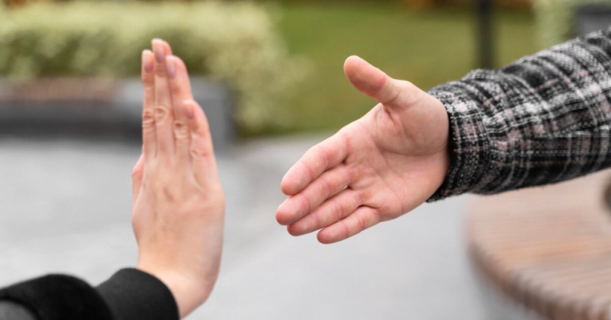 A man refusing a handshake 