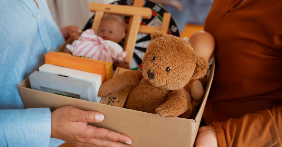 A woman giving away a child's toys