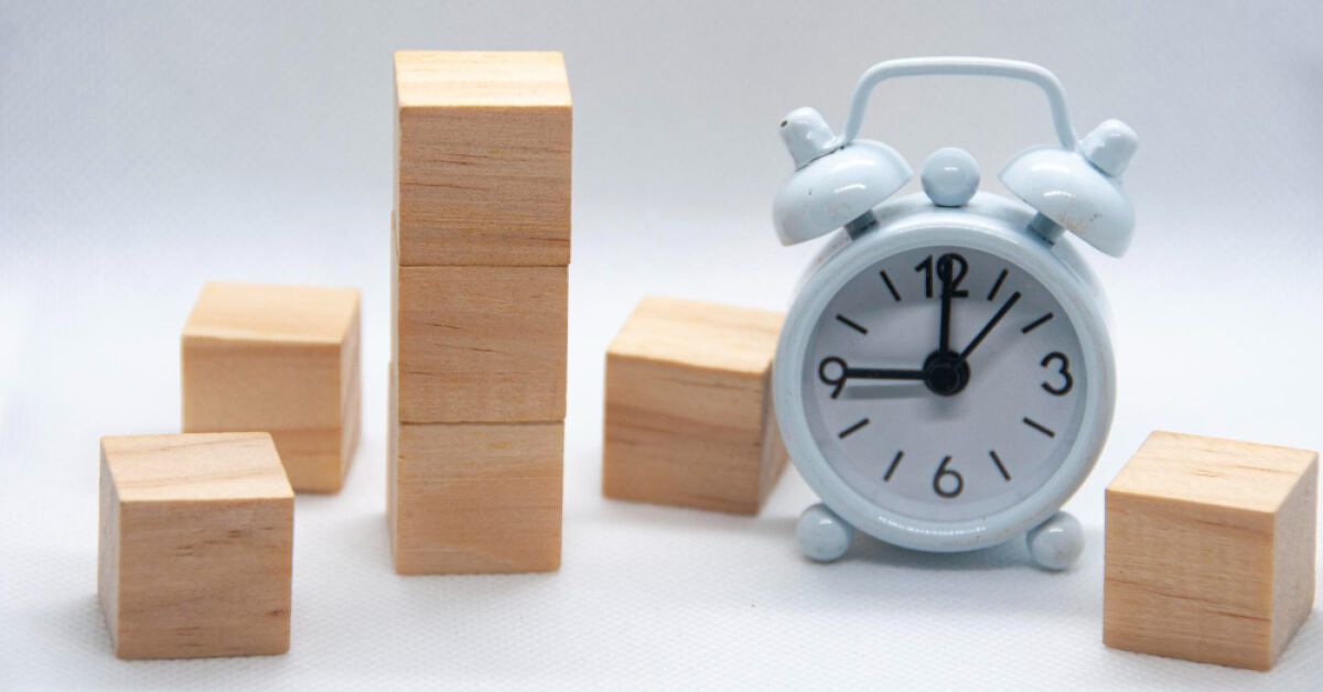 A clock next to wooden blocks