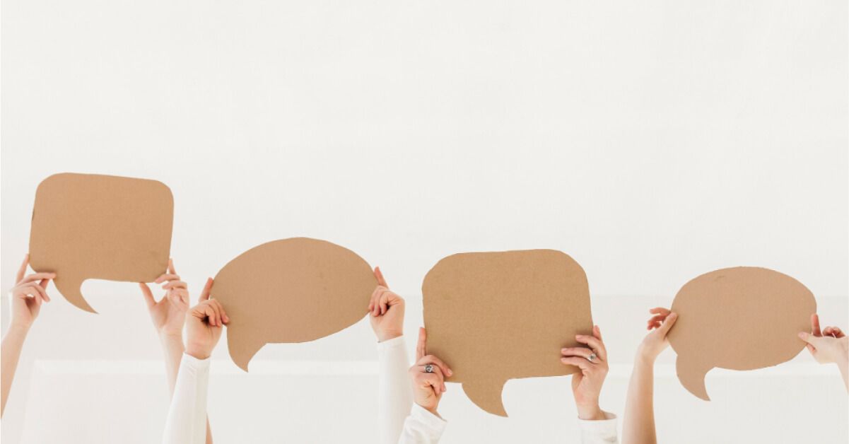 Women holding speech bubbles