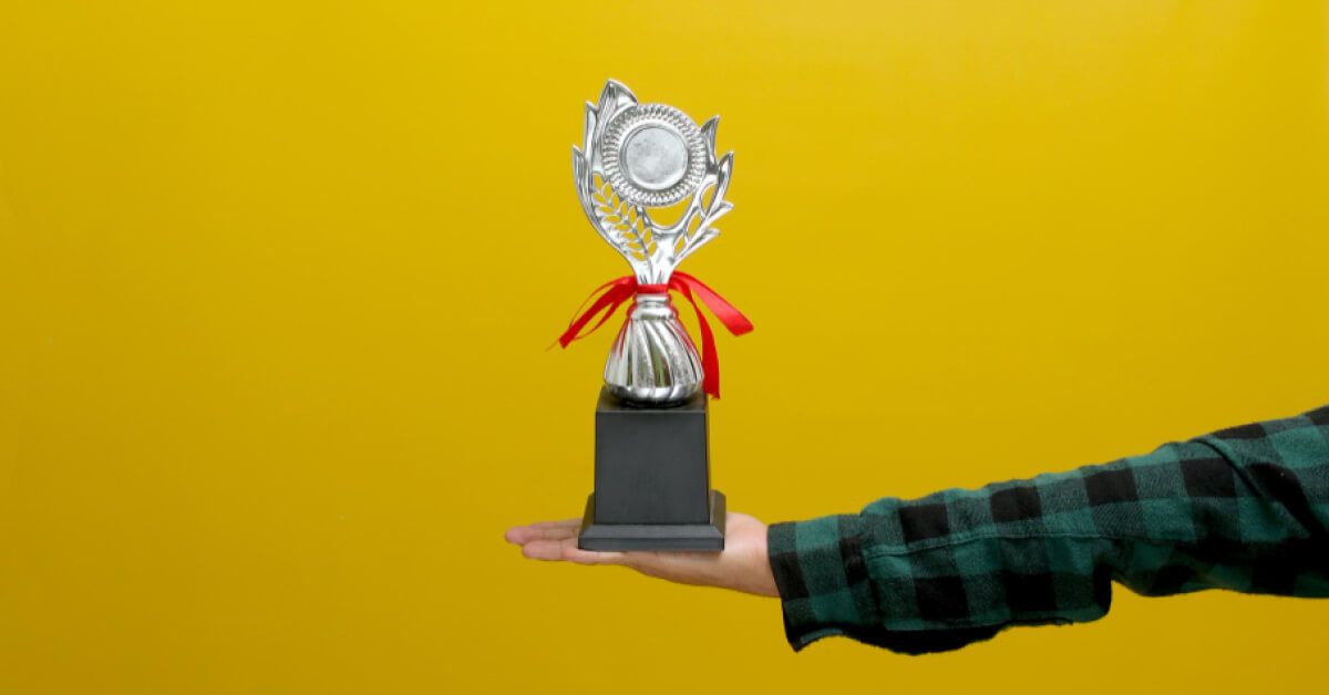 A person holding an award