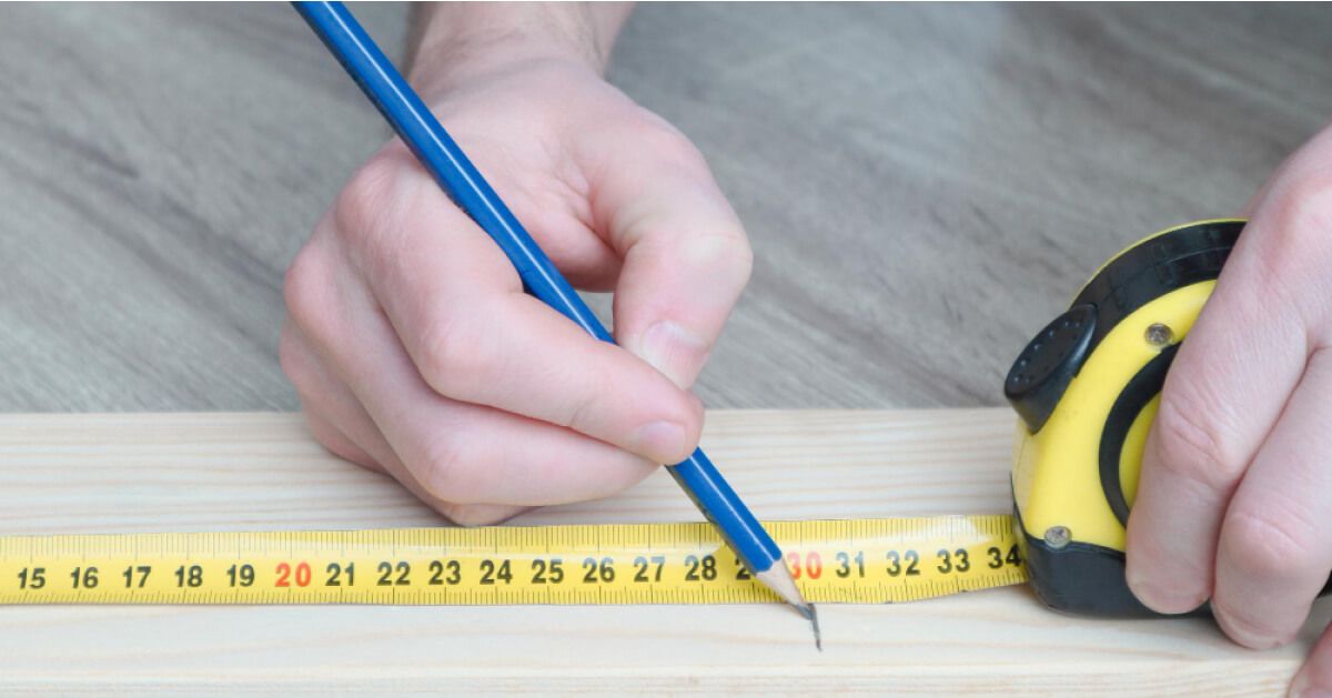 A person measuring with a measuring tape 