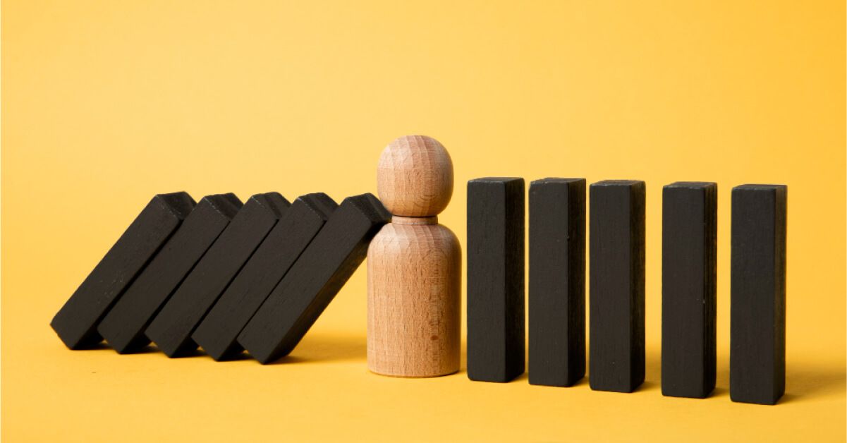 A wooden piece blocking a domino fall