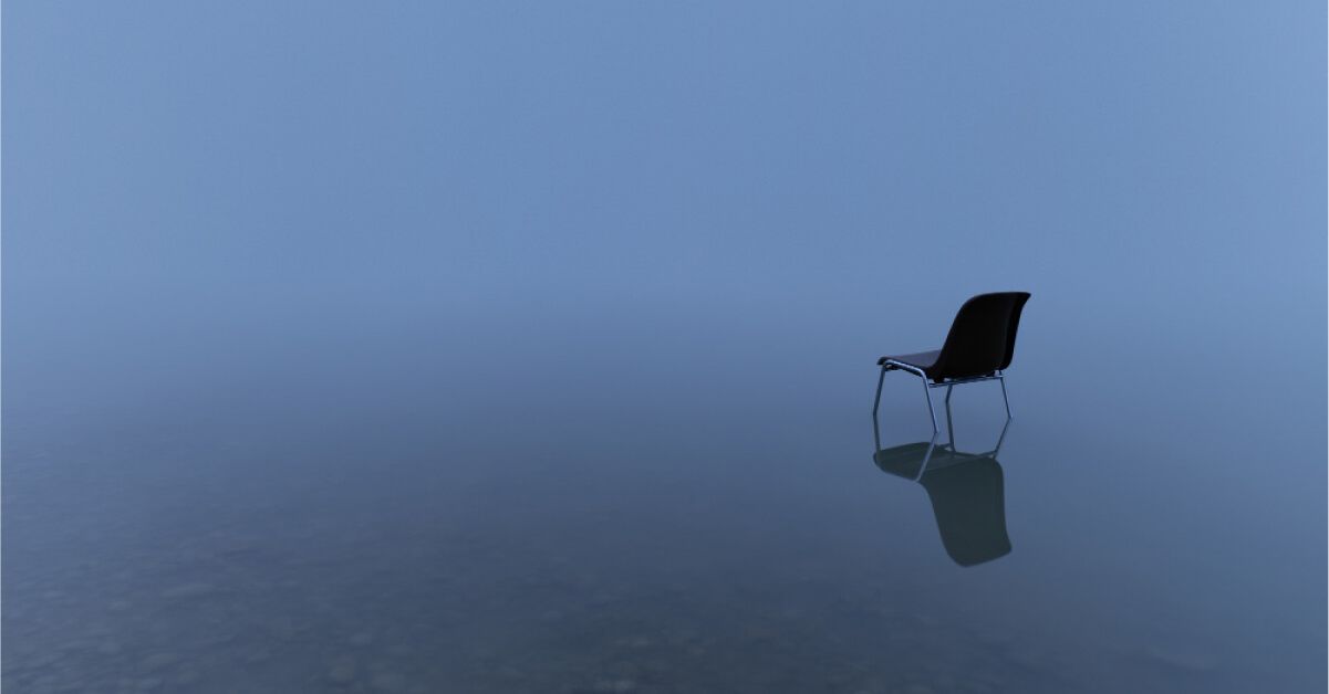 A black chair in the middle of a lake