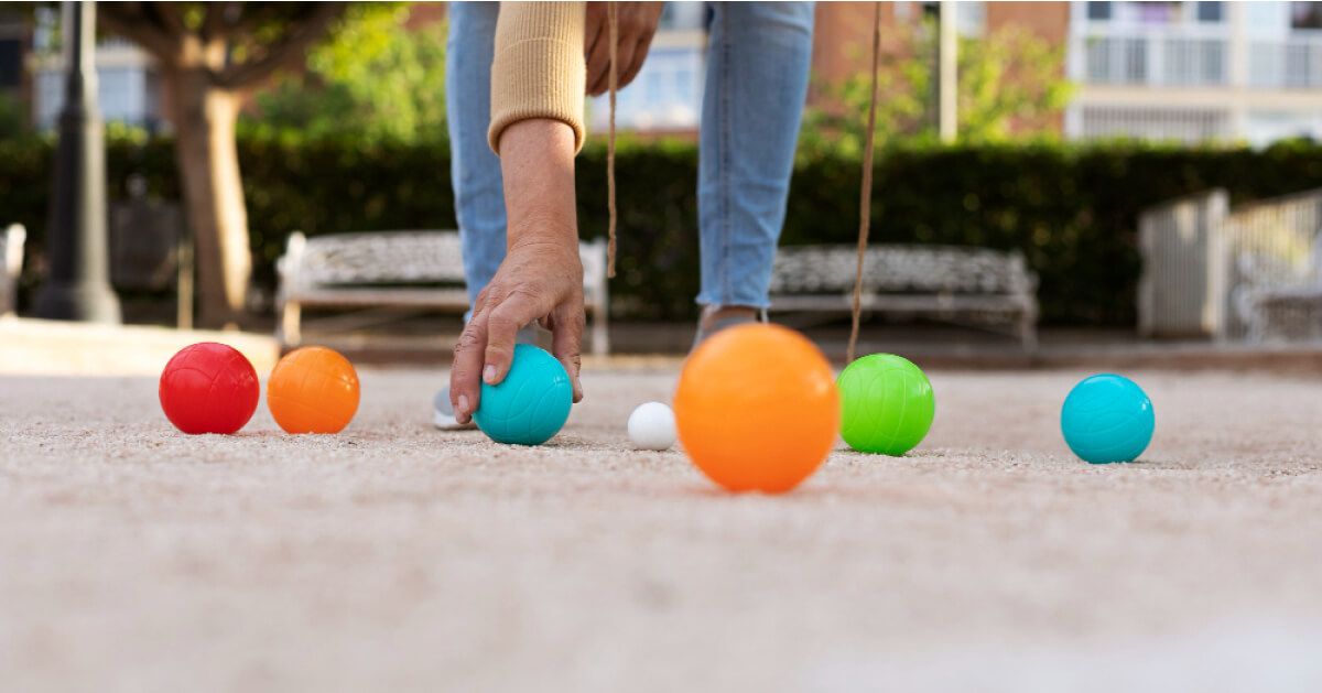 A person collecting balls from the floor