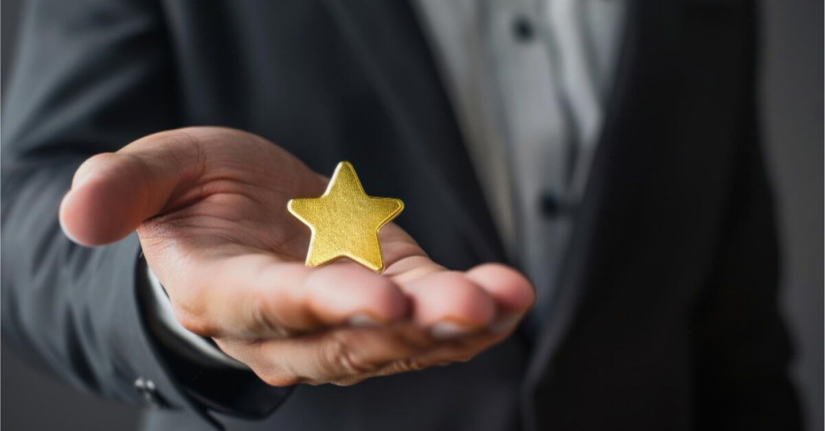 A man holding a golden star