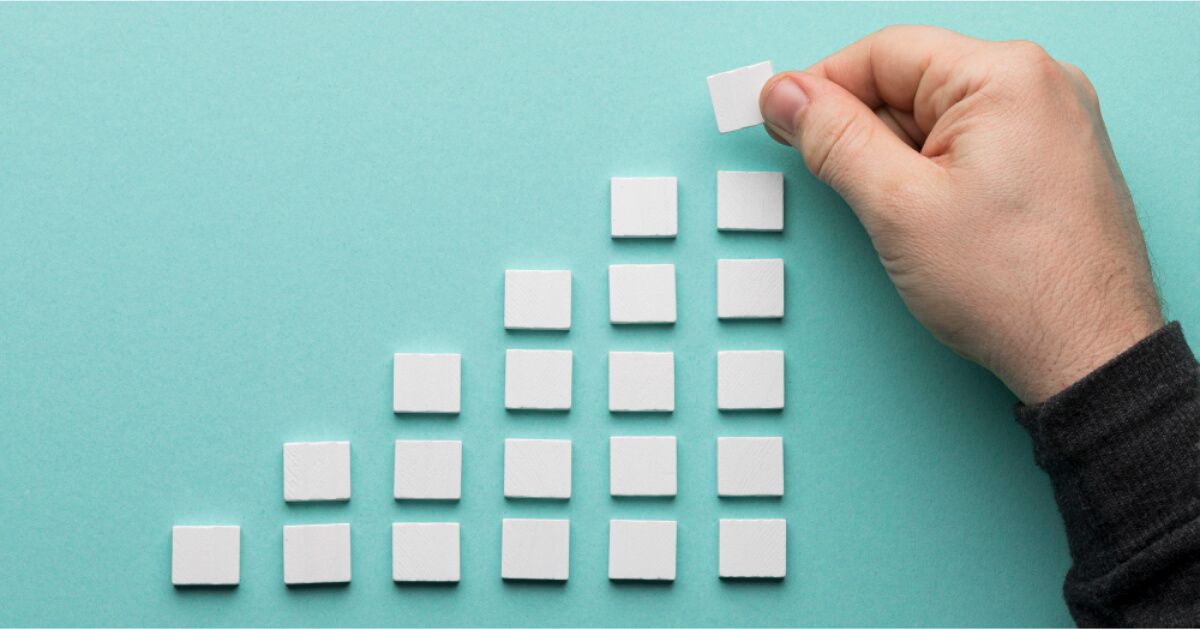 A man arranging square pieces