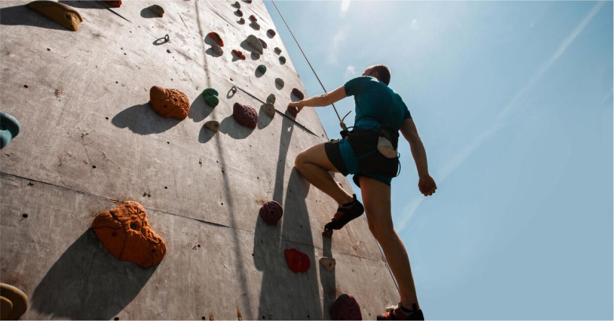 A man climbing the rock wall