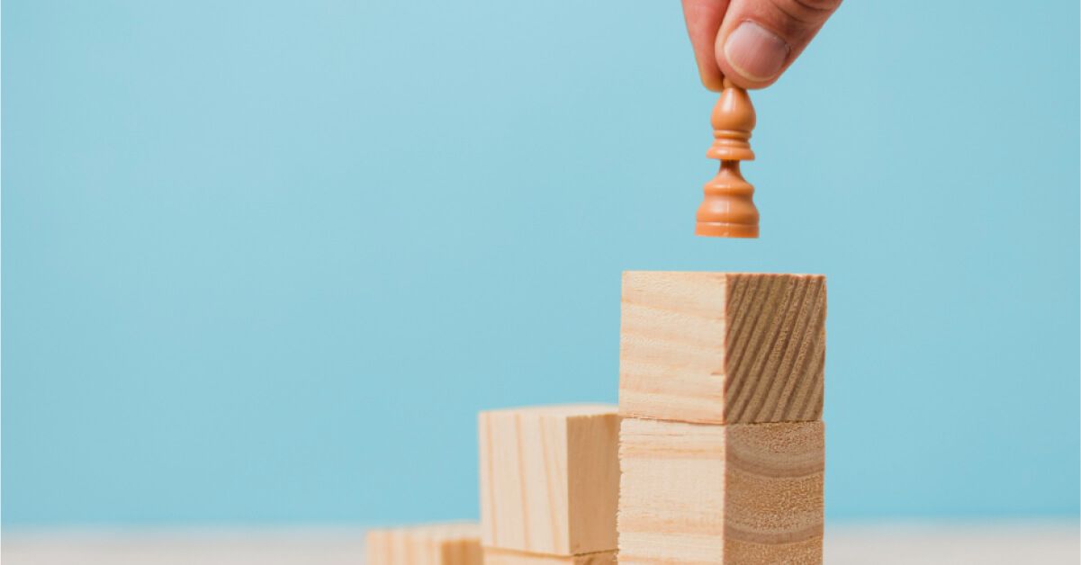 A chess piece on wooden blocks