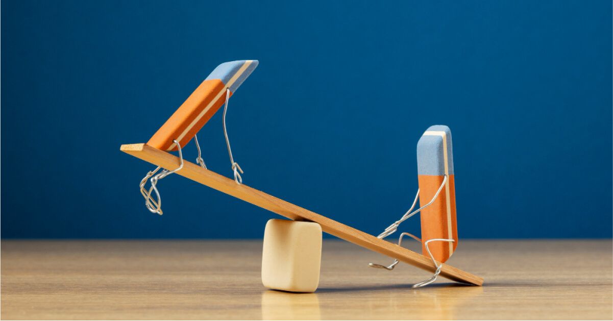 Two erasers playing on a seesaw