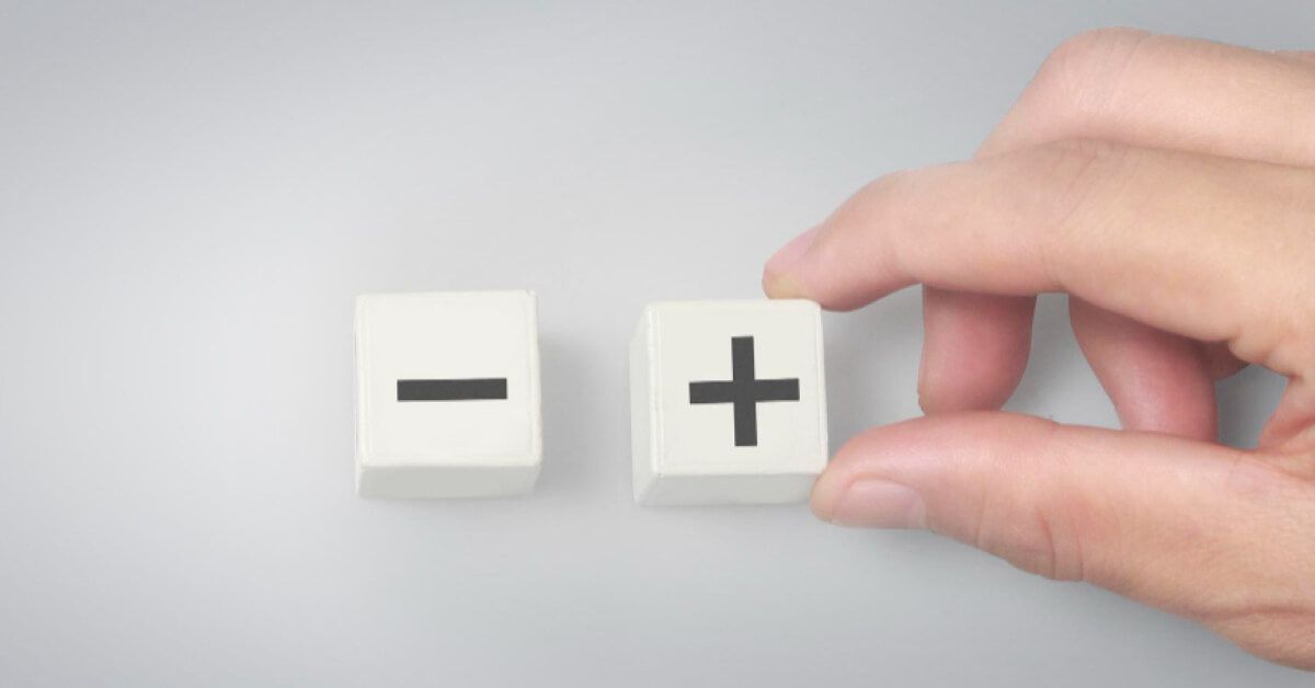 minus and plus symbol on two white cubes