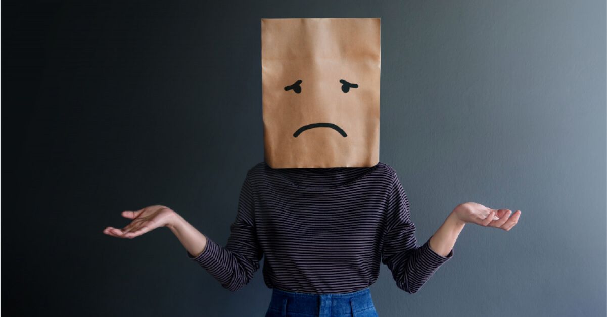 A person with a paper bag on her head