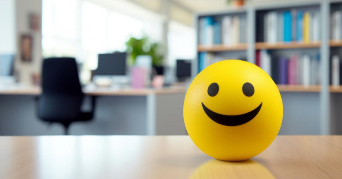 A smiley ball on a work desk