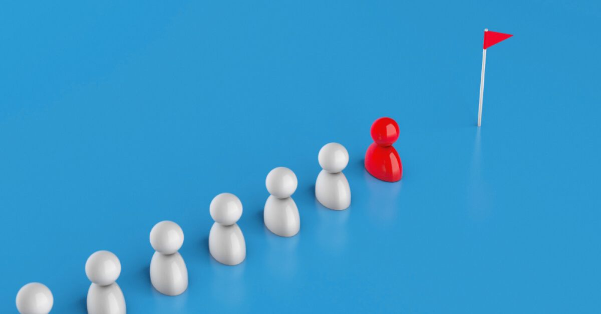 Figurines standing near a flag post