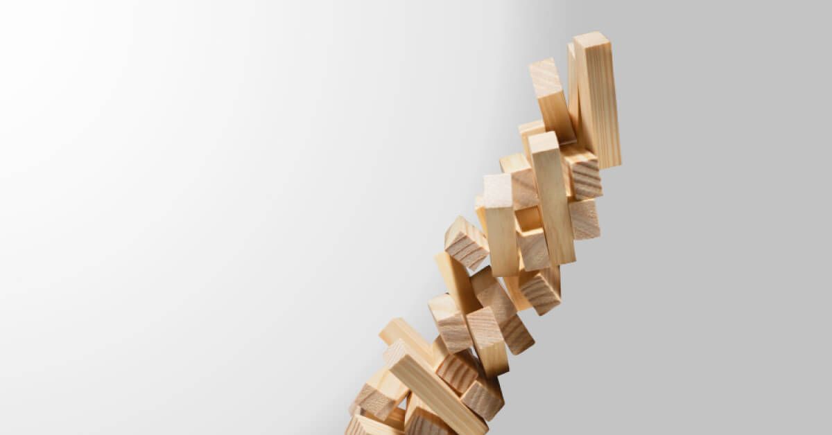 A tower of wooden blocks are falling