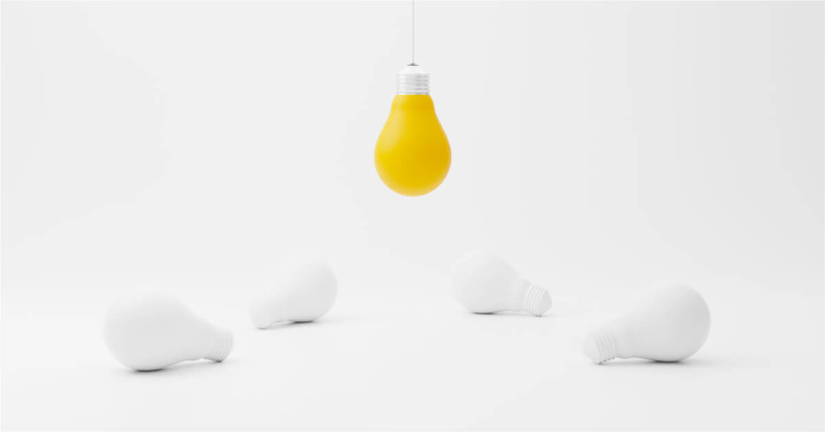 A yellow light bulb hanging from the ceiling