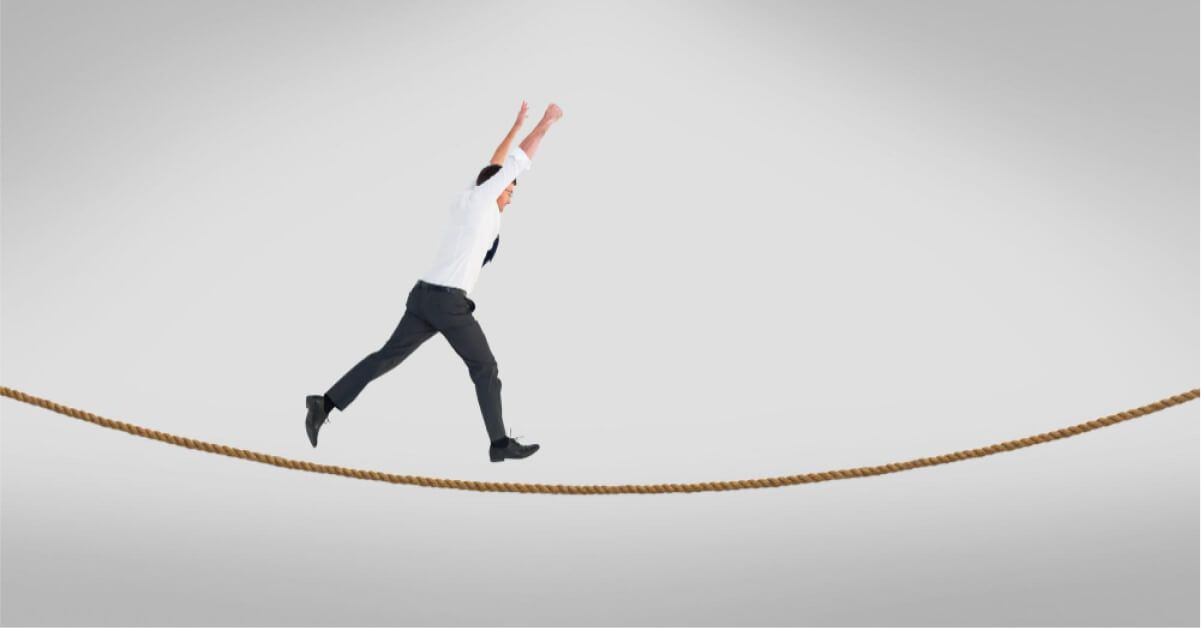 A male employee walking on a rope 