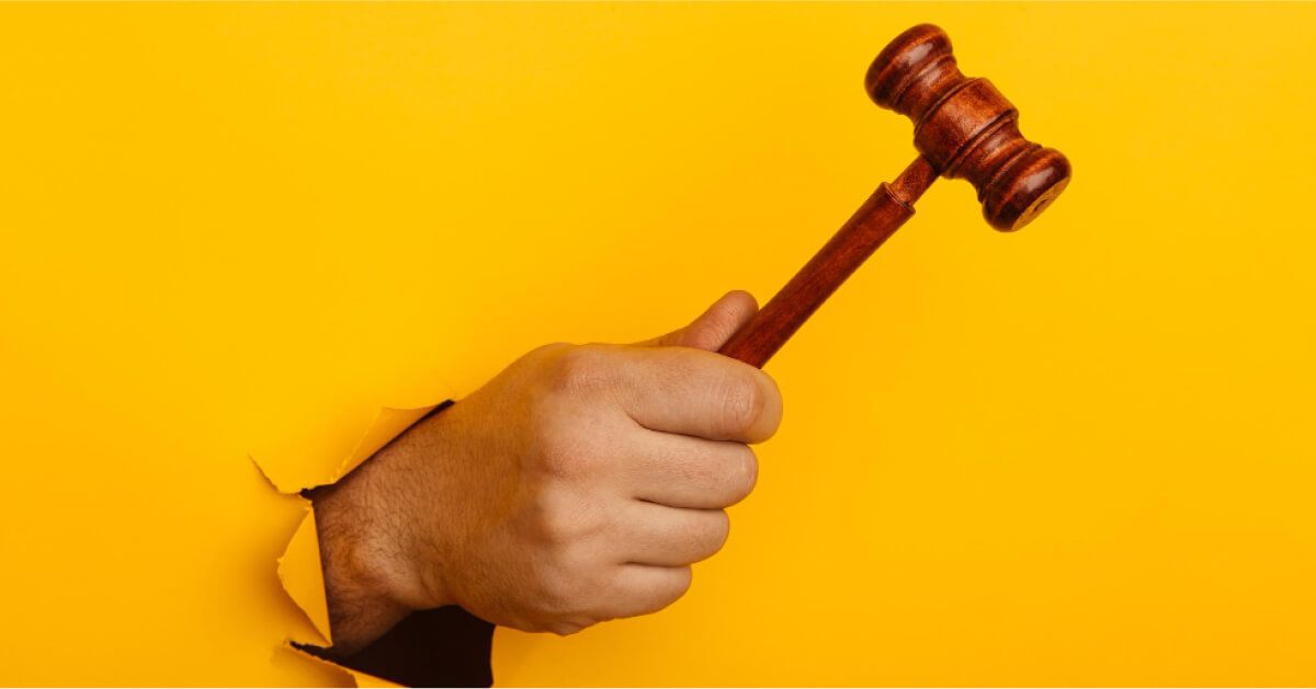 A man holding the wooden gavel 