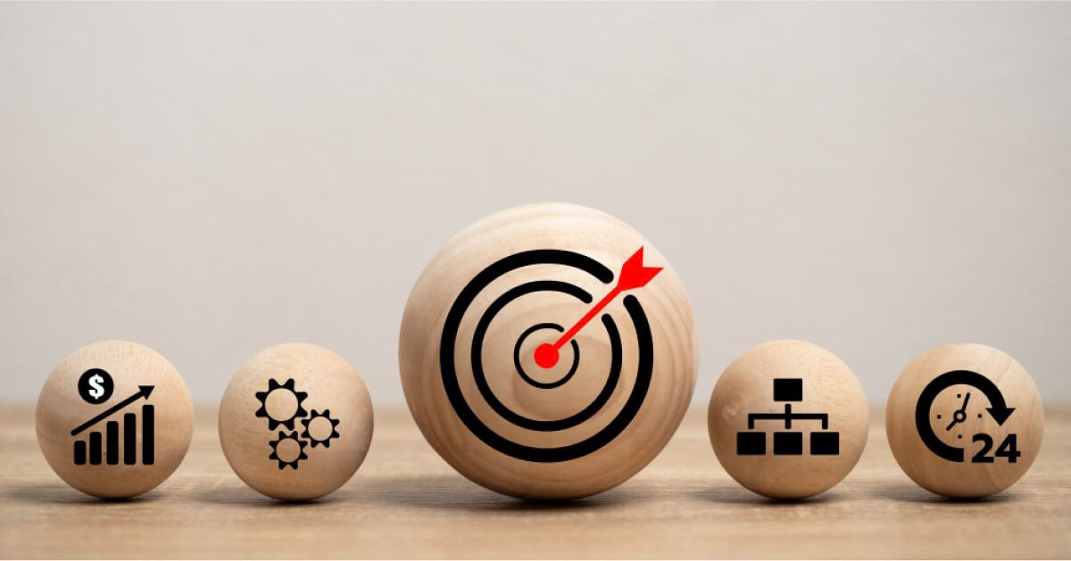 Wooden balls with business icons representing growth, teamwork, focus, structure, and 24/7 support