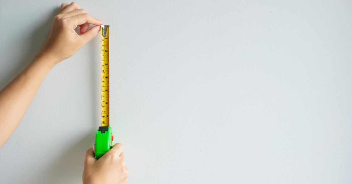 A person holding a measuring tape