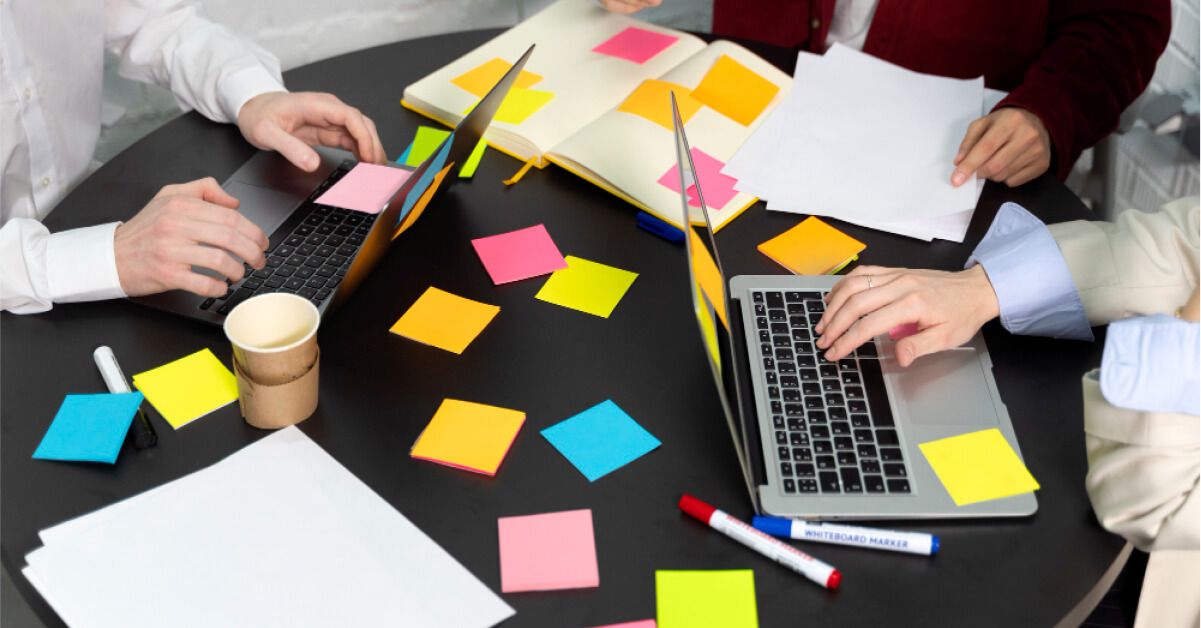 Employees are working together with a lot of sticky notes around 