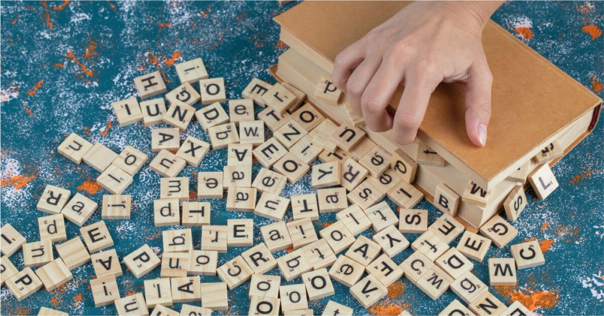 Scrabble letters falling out of a box