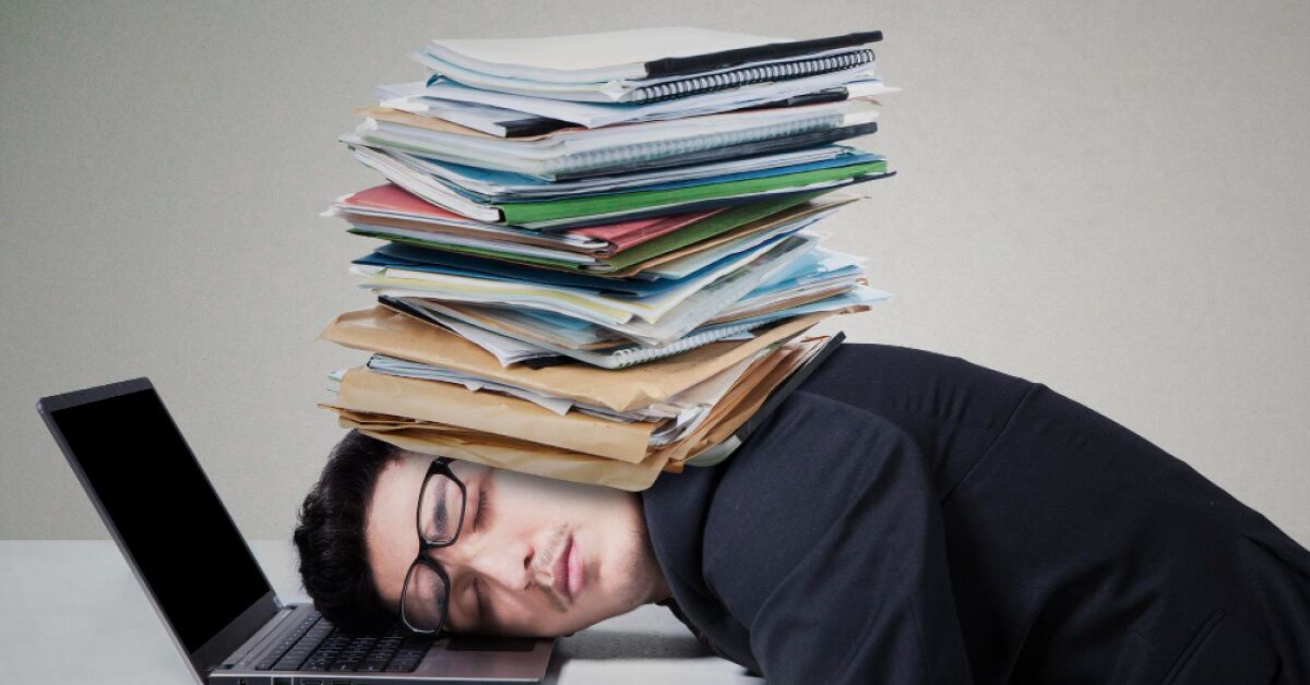 A man with a pile of books on his face