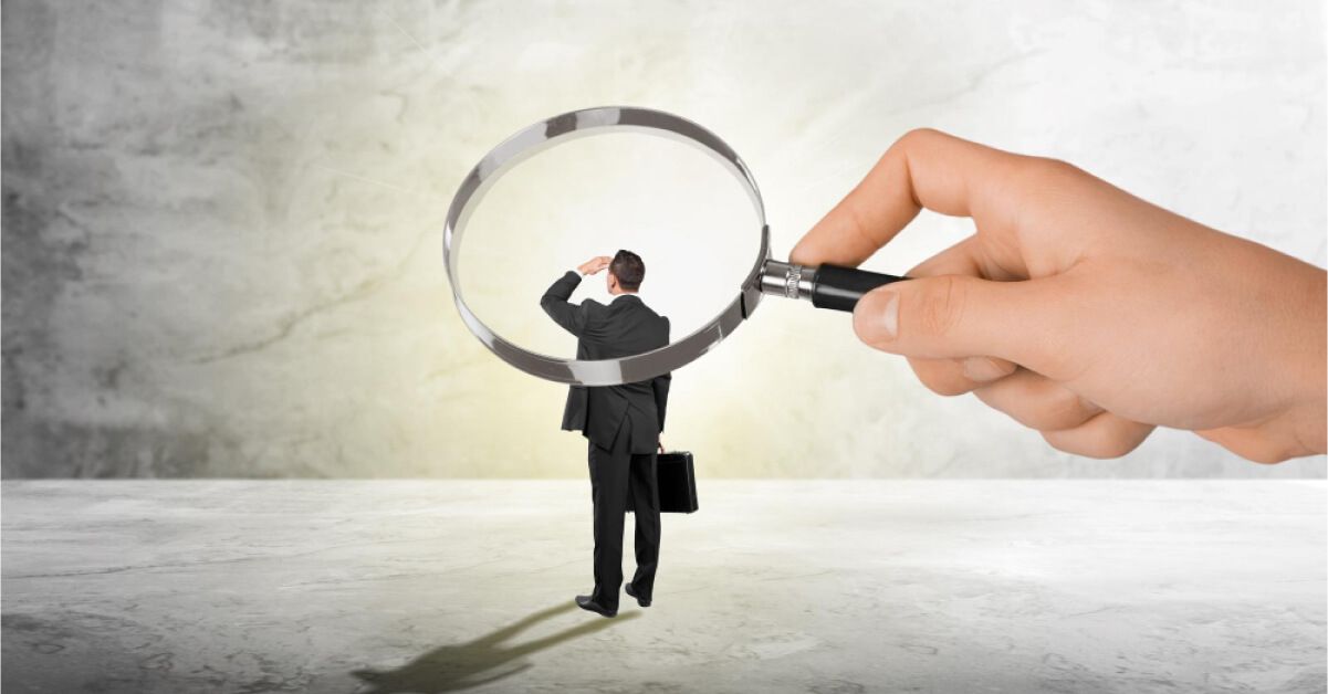 A magnifying glass on a man