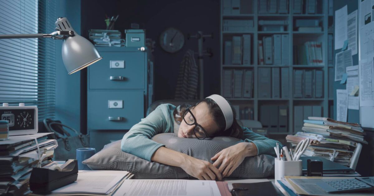 A young employee sleeping because of burnout