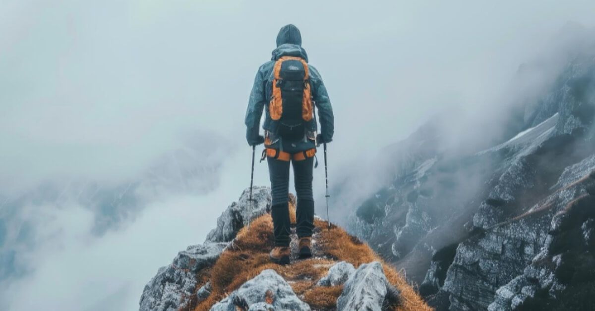 A man standing at the top of a mountain