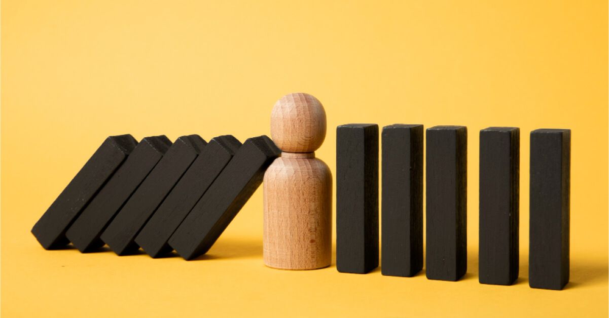 Jenga pieces balancing on a figurine