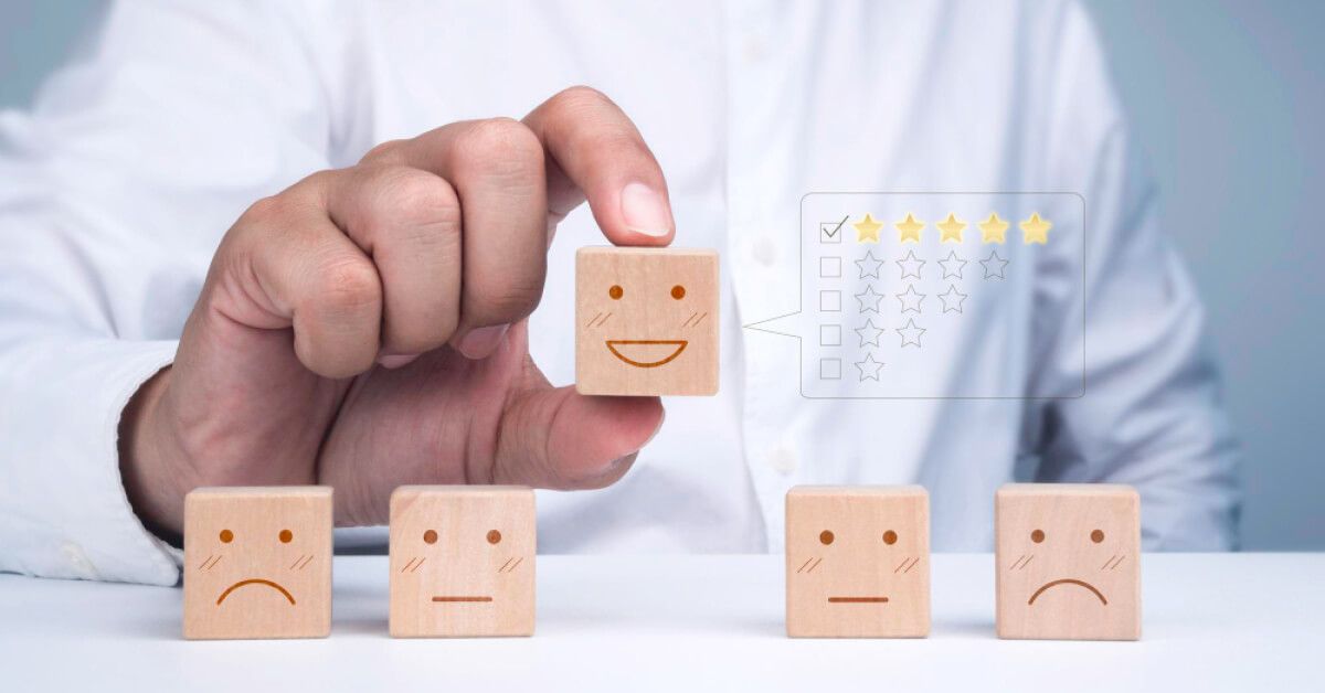 An employee holding up a wooden block as feedback