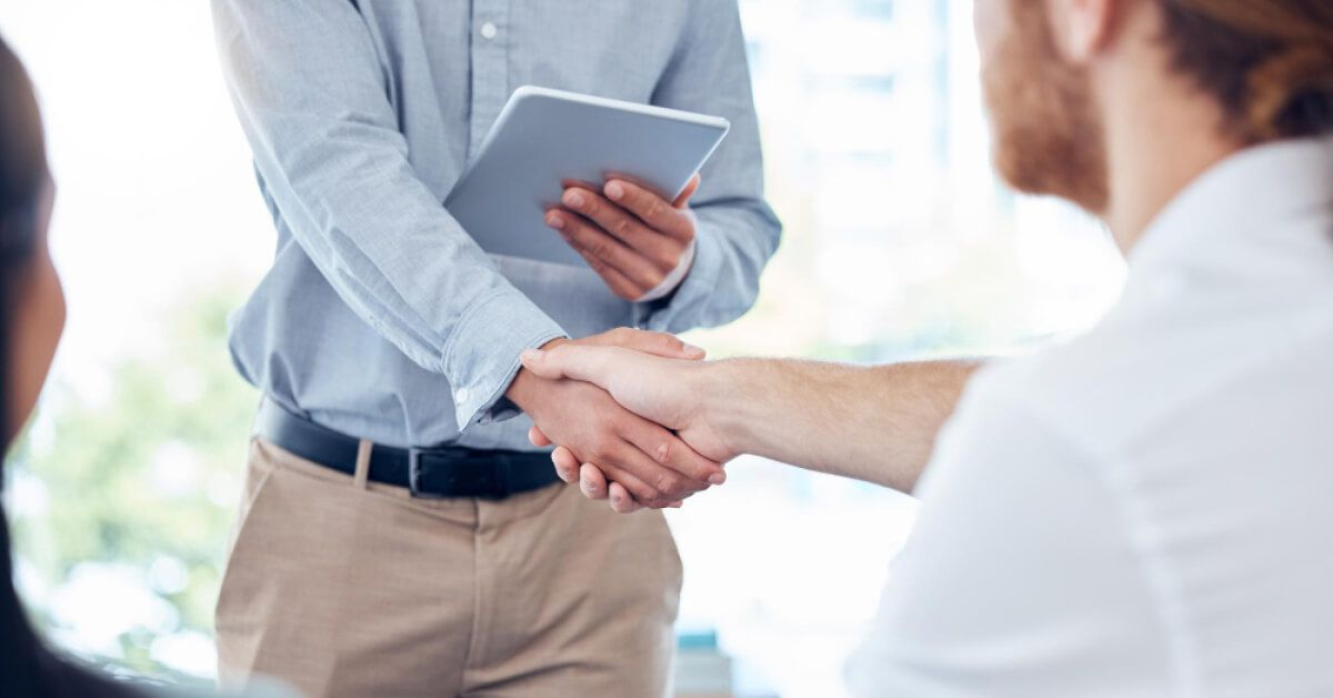 People shaking hands in a team meeting