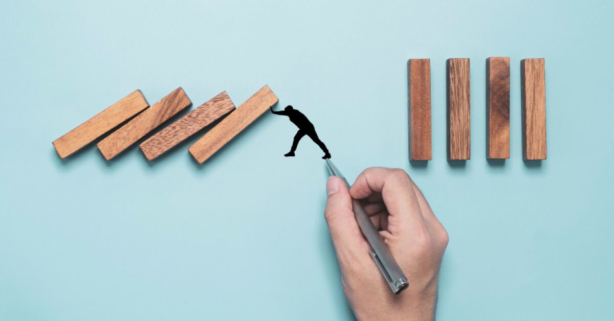 Jenga pieces balancing on a figurine