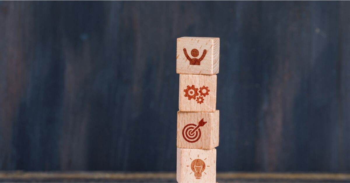 Wooden blocks with engraved icons, placed on top of each other