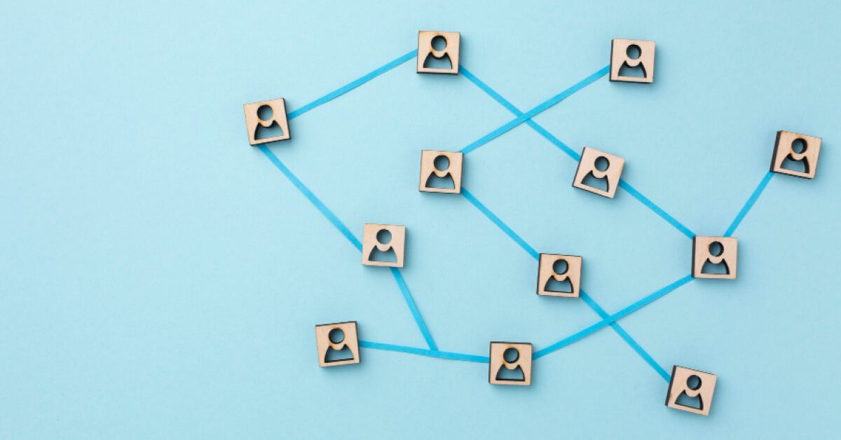 Cardboard cutouts of a network of people connected by blue lines