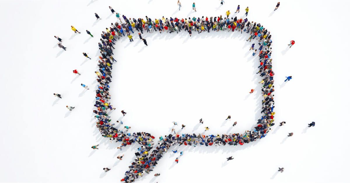 Top down shot of a group of people arranged together to form a speech box