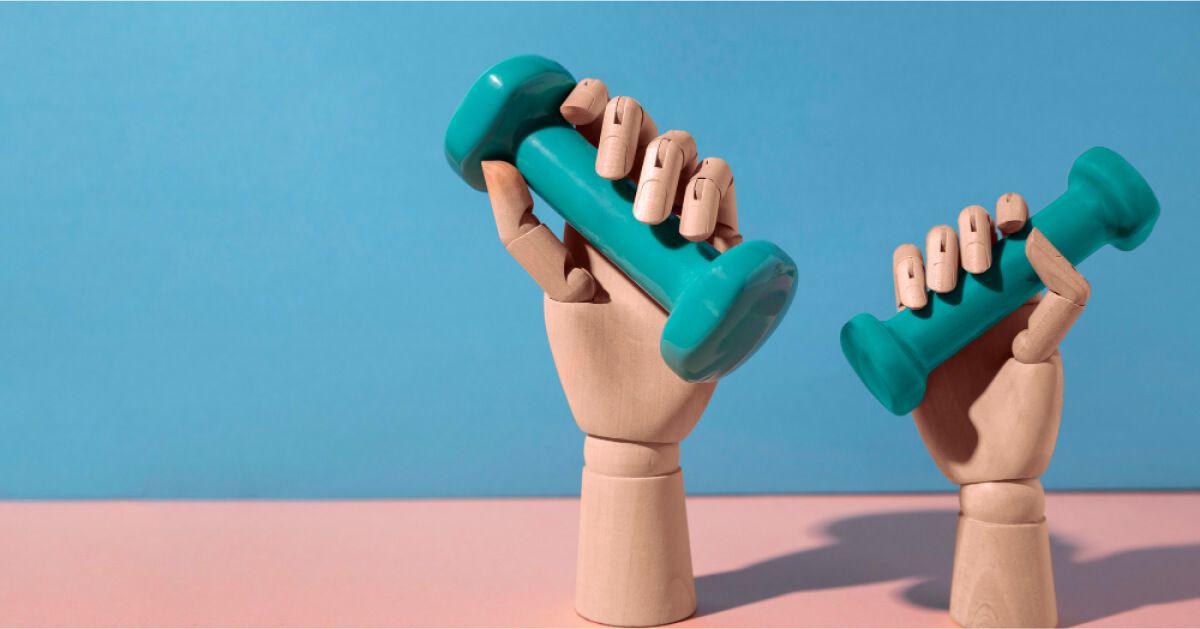 Two hands holding dumbbells